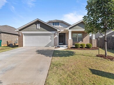 Craftsman house with a front lawn and a garage