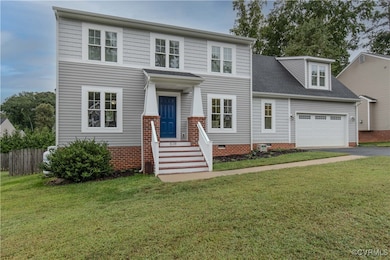 The home features a durable brick and vinyl facade