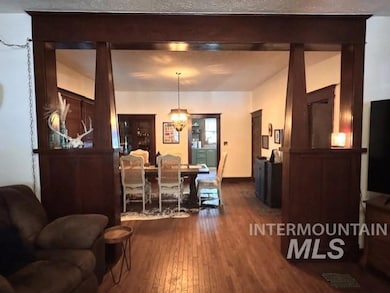 Dining area featuring dark wood-style floors and a chandelier