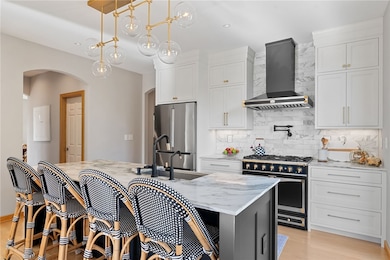 Breathtaking kitchen finished with Restoration Hardware light fixtures and hardware.