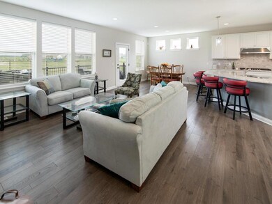 Living and dining room filled with light from the many windows