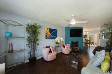 Living room features modern light fixtures and bea