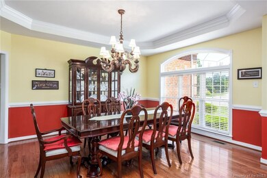 Formal Dining Room with crown molding, chair rail and hardwood floors.