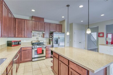 Gourmet island kitchen featuring granite slab coun