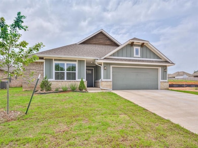 View of front of home with a garage and a front la