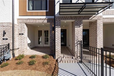 This inviting covered terrace-level patio features classic brick pavers that lend warmth and charm to the outdoor space.