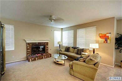 Large family room with fireplace extends off of th