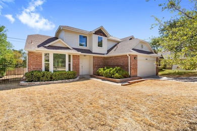 The home sits on a quiet, tree-lined street with mature landscaping that enhances its charming curb appeal.