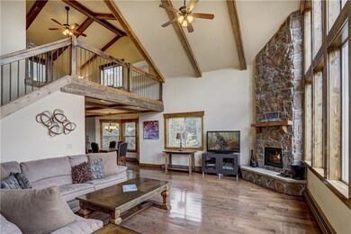 Floor to ceiling stone wood-burning fireplace in g