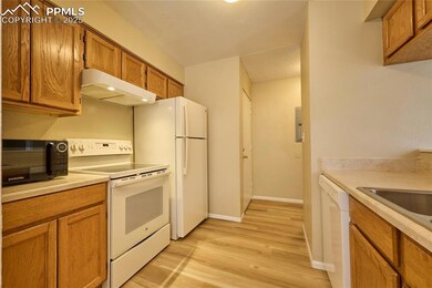 Kitchen with brown cabinetry, light wood finished 