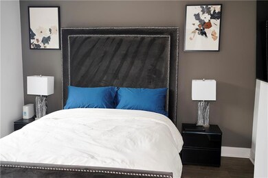 Bedroom with dark hardwood / wood-style floors