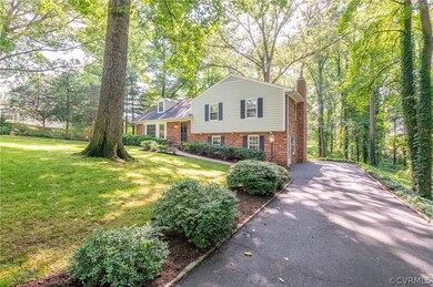 Paved driveway is extra wide and stone-lined.