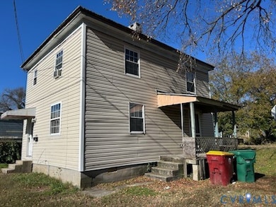 Side of property featuring a porch
