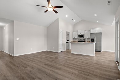 Kitchen featuring open floor plan, a ceiling fan, 
