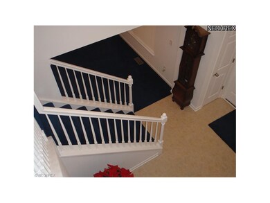 Two story foyer with stunning staircase.