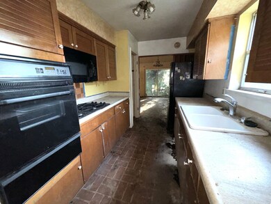 Kitchen with black appliances and sink