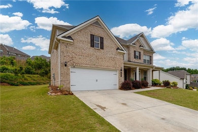 View of front of home with brick siding, driveway,