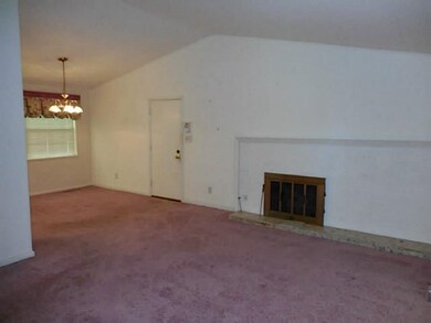Living Room. Vaulted ceilings gas log fireplace open dining to living area.
