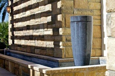 This dramatic urn fountain in the entryway attests