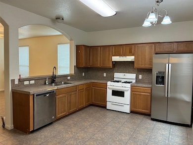Kitchen with brown cabinets, a sink, under cabine