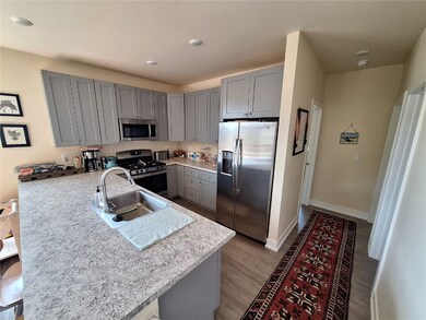 Kitchen featuring kitchen peninsula, gray cabinets