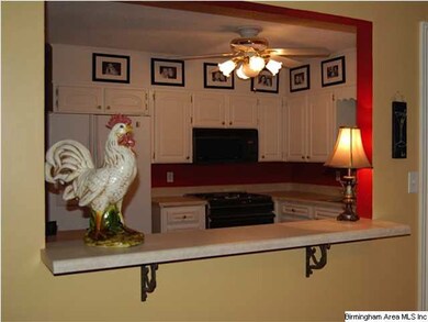 THE BREAKFAST BAR OPENS INTO THE DINING ROOM