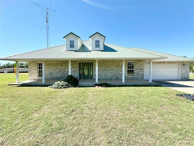 View of front facade with a front yard, a garage, 