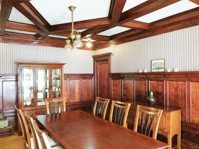 Large Dining Room has original wood paneled walls.