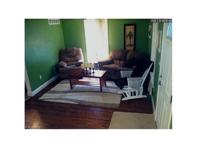The living room has refinished hardwood floors, wh