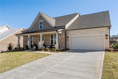 Craftsman inspired home with a front lawn, roof with shingles, covered porch, a garage, and driveway