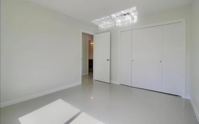 Unfurnished bedroom with a closet, visible vents,
