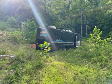 RV on concrete slab past the garage