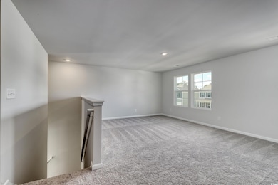 Carpeted spare room with recessed lighting and bas