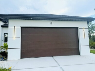 Garage featuring concrete driveway