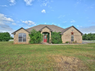 View of front of property featuring brick siding and roof with shingles