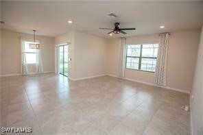 Empty room featuring ceiling fan, plenty of natura