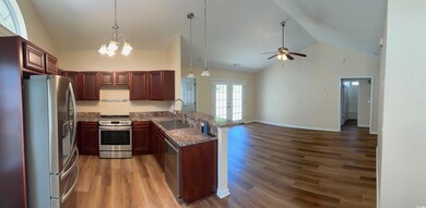 Kitchen featuring a peninsula, open floor plan, li