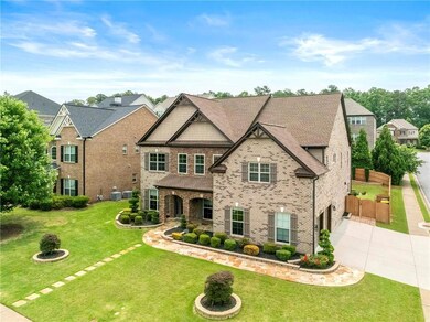 View of front of house featuring concrete driveway, an attached garage, brick siding, and a front lawn
