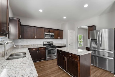 Kitchen featuring stainless steel appliances, a si
