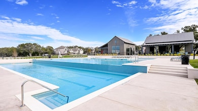 Community pool with a patio