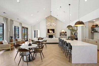 Dining room featuring a fireplace, high vaulted ce