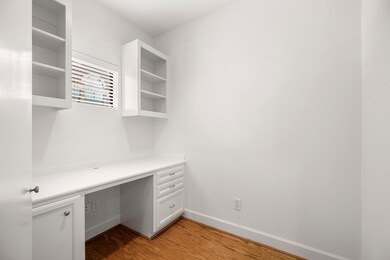Home office features a built-in desk and storage.