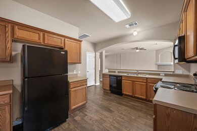Kitchen featuring visible vents, a ceiling fan, a