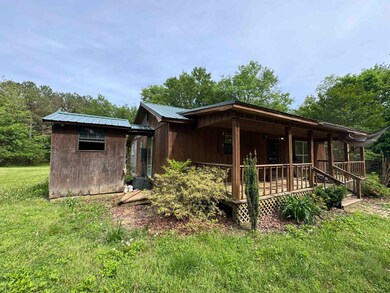 View of front of property with a porch and metal r
