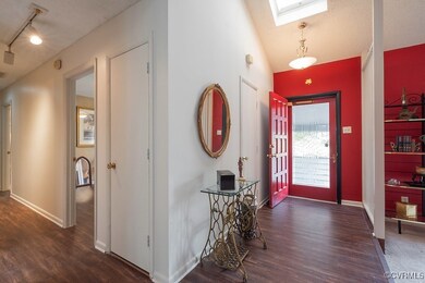 Entrance foyer with a textured ceiling, rail light