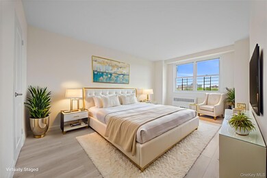 Bedroom featuring wood finished floors and radiator heating unit