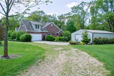 Enjoy the pace of country living!  The 5-acre property is level and cleared with lush landscaping around the house and workshop.  Sloped and wooded perimeter ads to the charm and privacy in this peaceful setting.  There is a large, circle gravel driv
