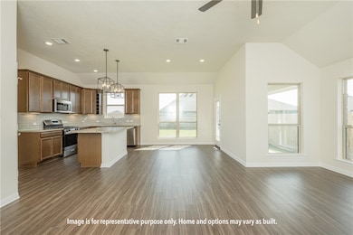 Kitchen with appliances with stainless steel finishes, open floor plan, tasteful backsplash, dark wood-style flooring, and a kitchen island