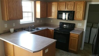 Open kitchen with breakfast bar, newer dishwasher,