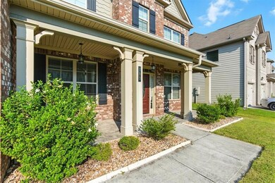 Entrance to property featuring brick siding and covered porch